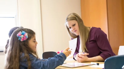 Graduate Education Literacy student, Kim Lotocki, works with children at Dunkirk School No. 3.