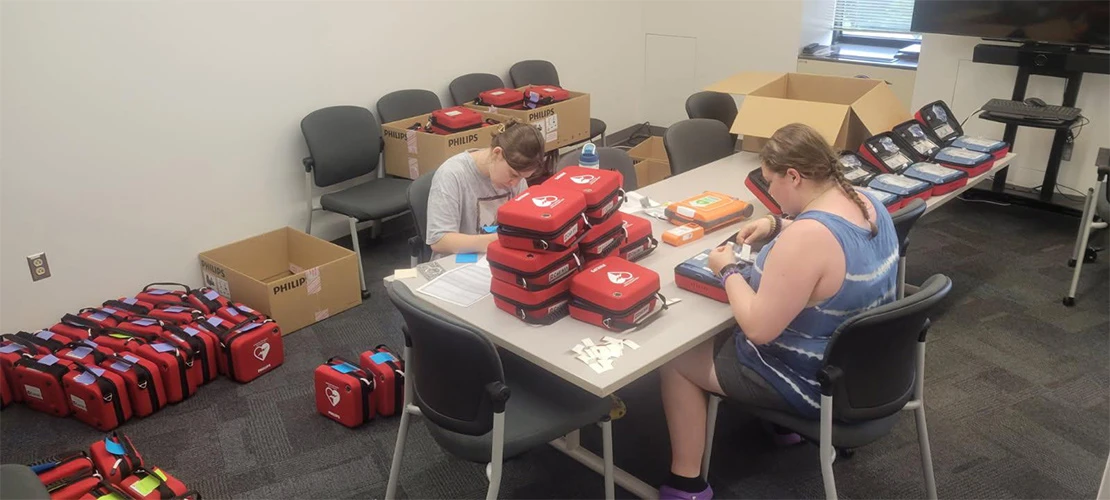 students assembling AED units