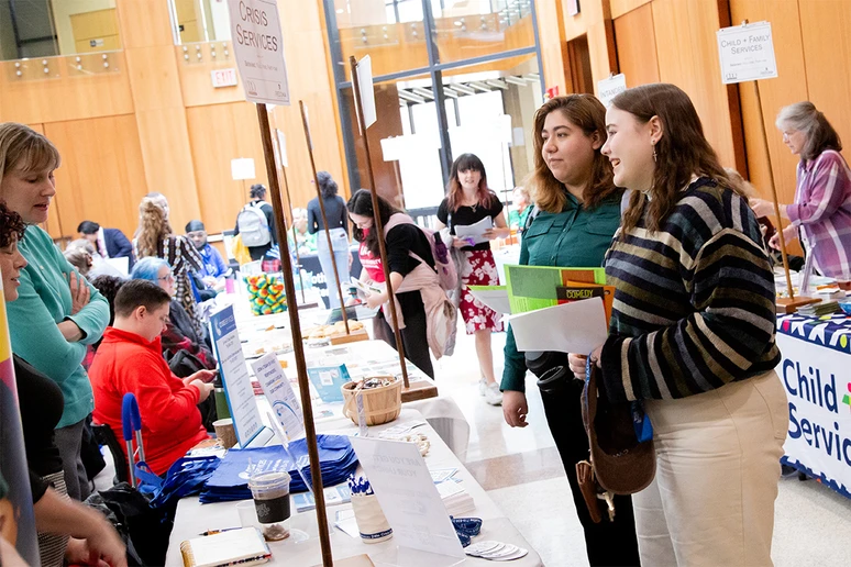 students at tables of potential employers in the Williams Center
