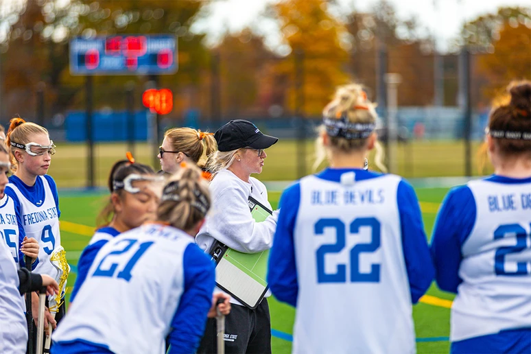 Coach Poffenberger coaching on the sidelines with athletes
