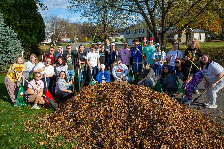 students in a group with rakes