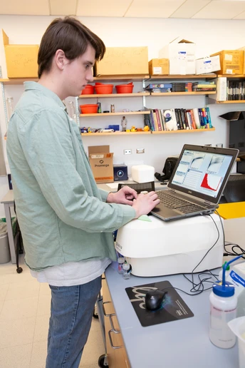 Utilizing a computer connected to a flow cytometer, Gavin Monaghan is able to view the profiles of literally thousands of cells at a rapid rate.