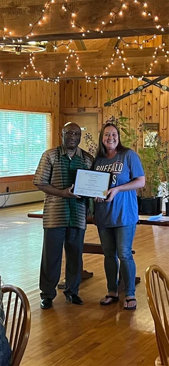 Alicia Klepfer receives her award from President Stephen H. Kolison Jr.