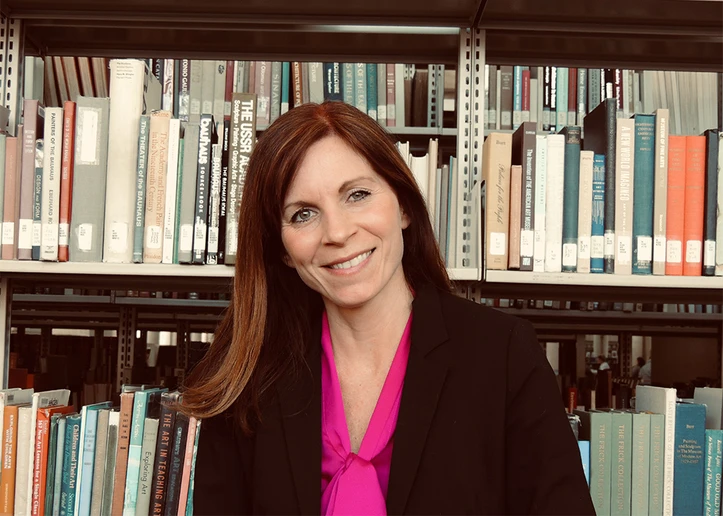 Dr. Emily VanDette in front of bookshelves