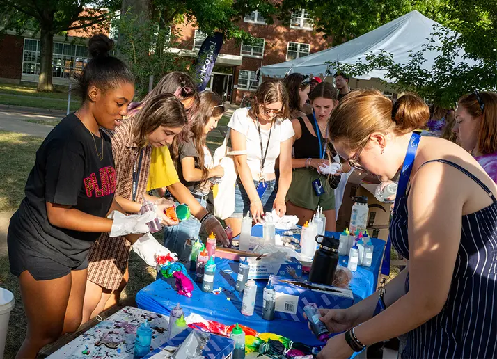 students sitting on the patio enjoying an event