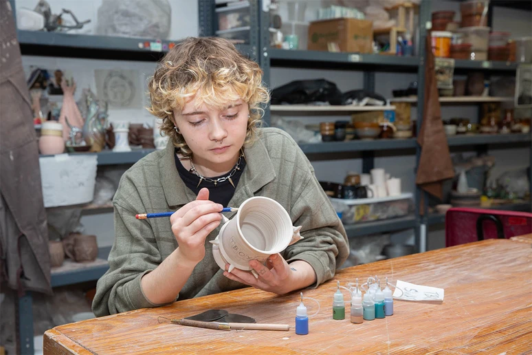 student working in the ceramics studio