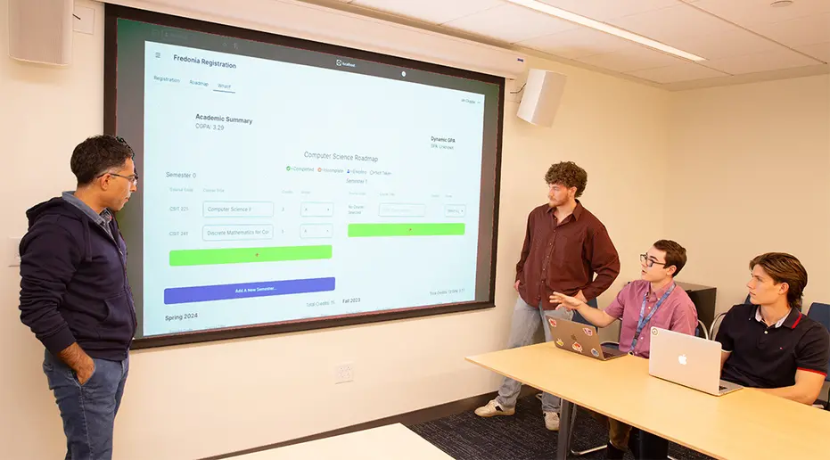 Reviewing how the Advising Roadmap is set up are (from left): Dr. Shahin Mehdipour Ataee and students who developed the app including Jared Russell, Ian Cioppa and Camron Walsh.