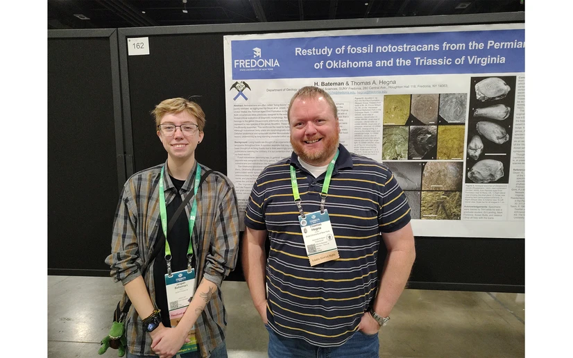 Jasper Bateman and Associate Professor Tom Hegna in front of their poster presented at the conference.