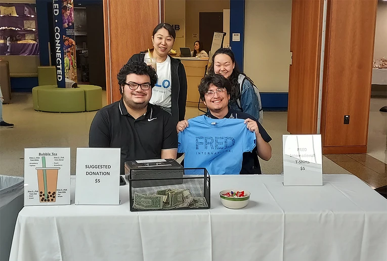 Welcoming guests at a recent Bubble Tea fundraiser are (front row, from left) Sabastian Montalban and Pedro Jesús Martínez; and (back row): Warabi Matsuoka and Fu Kikuchi, who are from Japan.