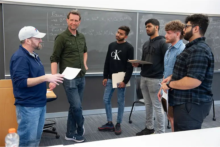 Joe Piacente and Ted Wojcik (far right) meet with Computer Science students following their informal presentation about careers in computer