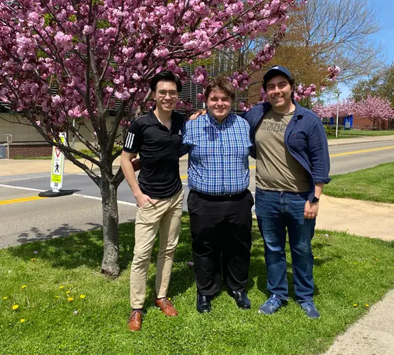 three Concerto Competition winners standing outside