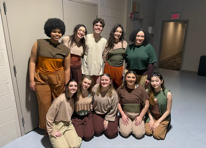 dancers in costume standing in a group