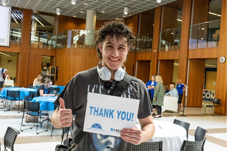 Lucas West holding Thank You sign.