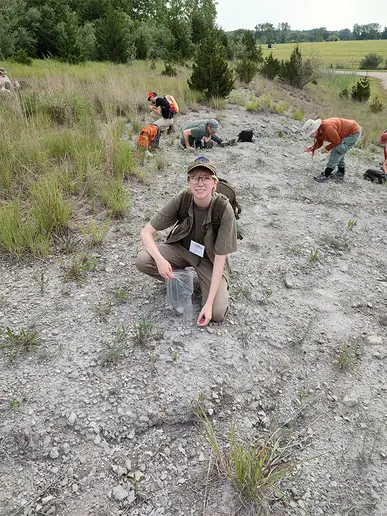 Jasper Bateman, looking for fossils in the Devonian Silica Shale during a mid-conference field trip, near Milan, MI. Inset photo of student at poster presentation