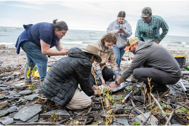 Randy Blood (far right) shows students how to properly wrap a core after it has been extracted.