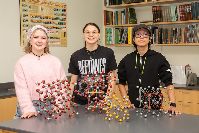 Gathering in a Houghton Hall lab are (from left): Mia Enders, Isabelle “Belle” Price and Nicky Flores.