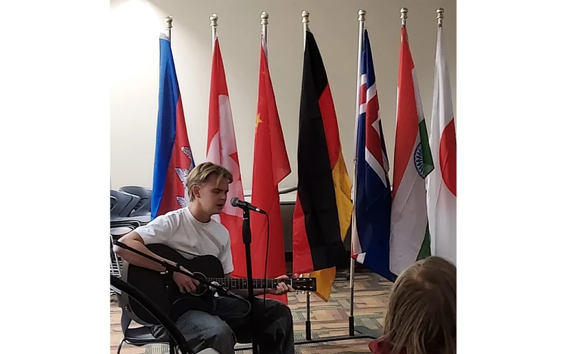 international student playing the guitar