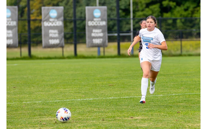 soccer player Annie Gondek running down the field by Travis Bernhard