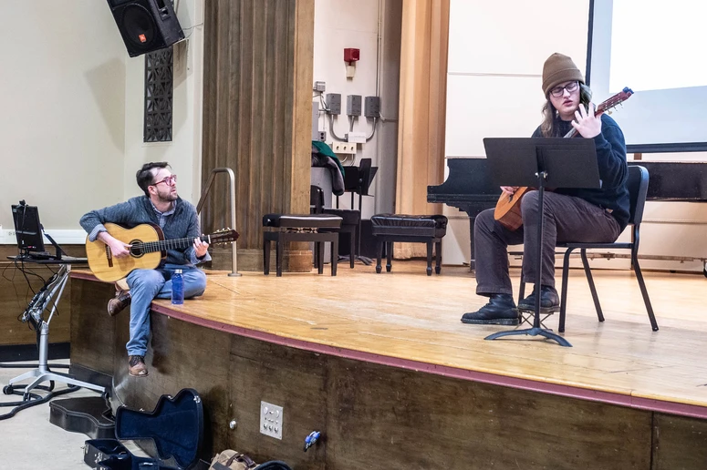 Dr. Nathan Huvard studies the fingering position of Justin Swan, a junior Sound Recording Technology major from Falconer, NY, as he plays a selection in Diers Recital Hall.