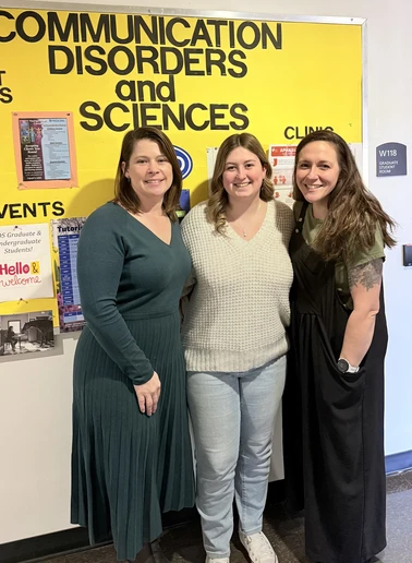 Hannah Belknap with two faculty members