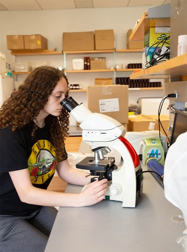 Sydney Hawkins at a microscope in the Science Center.
