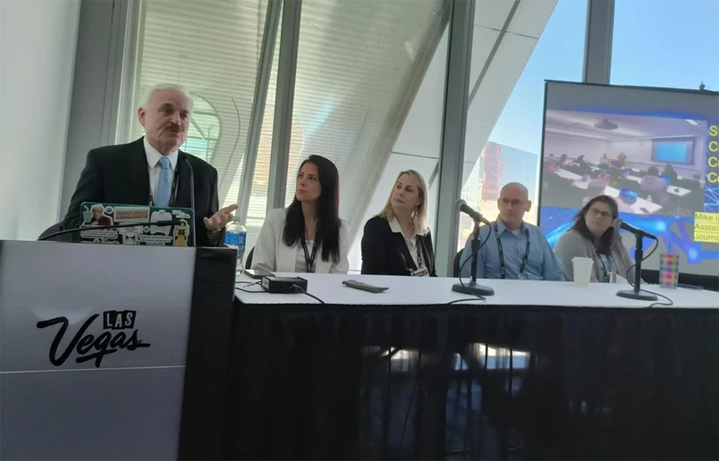 Mike Igoe (at lectern), serving in a panel discussion at the national Broadcast Education Association conference.