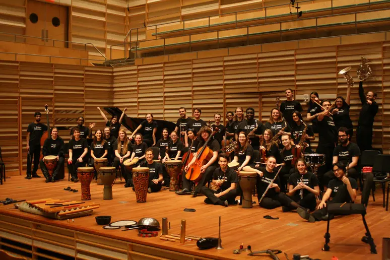 photo of group of musicians on stage with various instruments