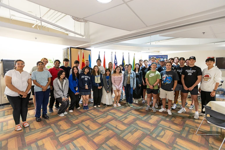 International students gather for a group photo at a reception in the Williams Center Horizon Room to welcome them to the campus for the fall semester.