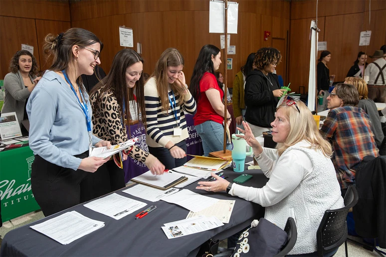 Amy Piper, a SUNY Fredonia alumnus and principal of Wheelock Early Childhood Center, discusses opportunities in the Fredonia Central School District with Macy Short, Holly Rohrbach and Alissa Dixon.