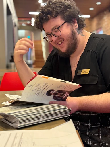 Jace Jacobs places a note, or insert, into programs for “Nina Simone: Four Women,” a recent production at Geva Theater, to indicate an understudy will appear in an upcoming performance of the drama.