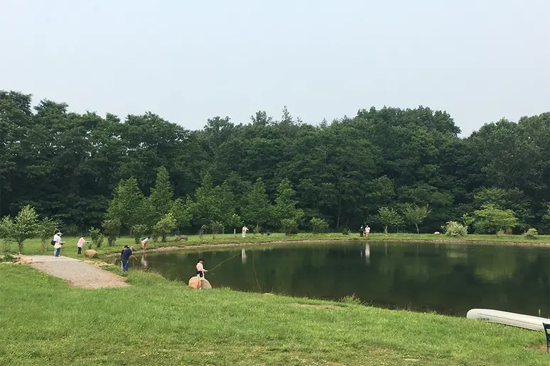 Japanese high school students join members of the Fly Fishing Club of Fredonia at a pond near Spoden Road in Fredonia.