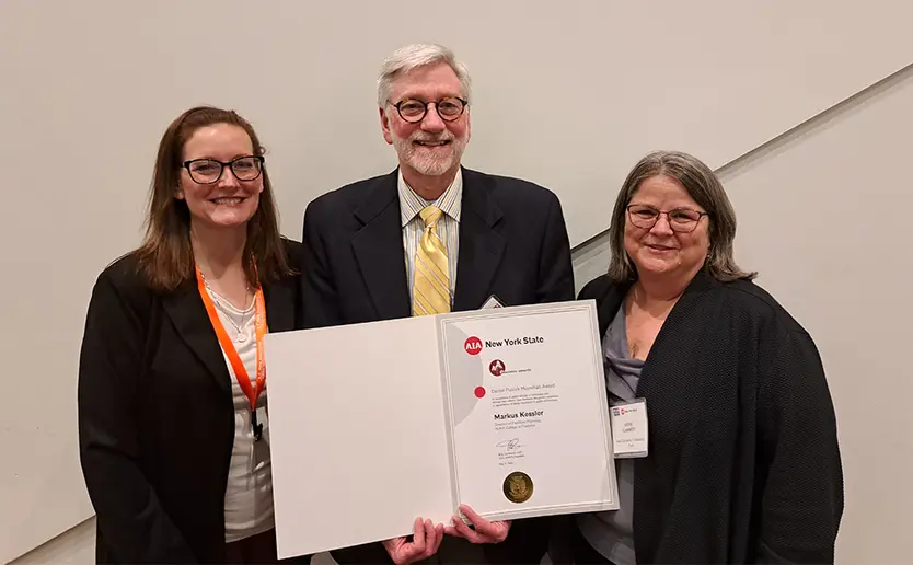 Markus Kessler, with Kimberly Conant (left), SUCF Regional Director for Design, and Anne Garrity, SUCF Director of Project Management, following the awards presentation.