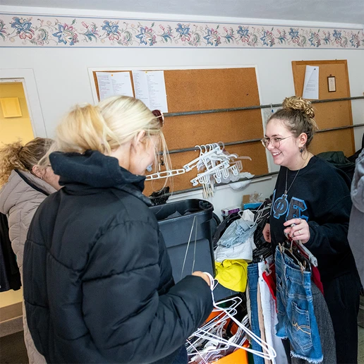 Helping to stock displays in the garment gallery are (from left): Audrey Foos, Megan Shaughnessy and Elizabeth Arrington.