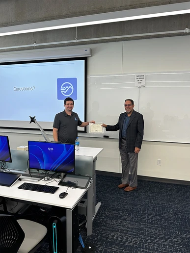 William House (left) and Dr. Junaid Zubairi display a certificate of appreciation he received from the Department of Computer and Information Sciences.
