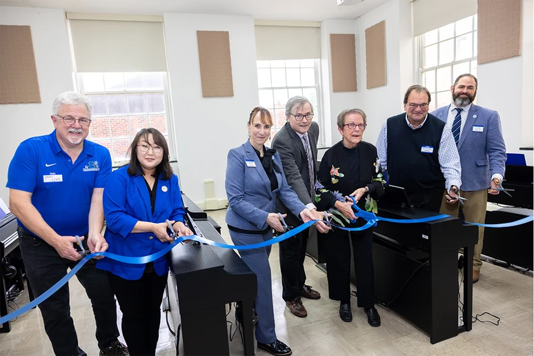 Emeritus Professor Phyllis East (third from right) and Yamaha representative Dom Cicchetti (second from right) join the Piano Lab ribbon-cutting ceremony with (from left) Operations Manager Marc Levy, Assistant Professor Jiyong Kim Mai, Vice President for Student Affairs Tracy Stenger, SUNY Distinguished Professor James Davis and Fredonia College Foundation Major Gifts Officer Tim Smeal.