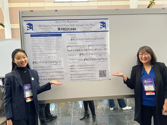 Dr. Xixi Shen (left) and Jiyong Kim Mai, with their “Developing Functional Piano Skills Through One Piece” poster, at the New York State School Music Association Winter Conference.