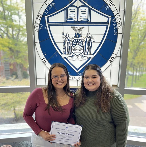 Mariana O’Meara (left), holding her Resident Assistant of the Month certificate, with Kasling Hall Residence Director Sabrina Sosa.