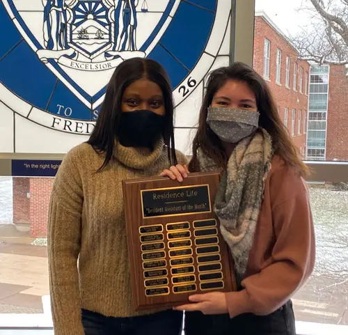 Amy Leogrande with Residence Director Fatihath Assani and plaque