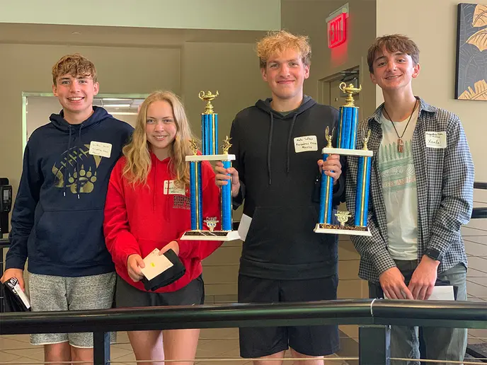 Winning student team with trophies