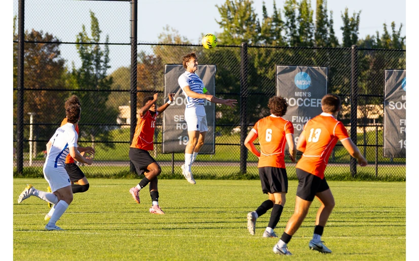 soccer players in action on the field by Travis Bernhard