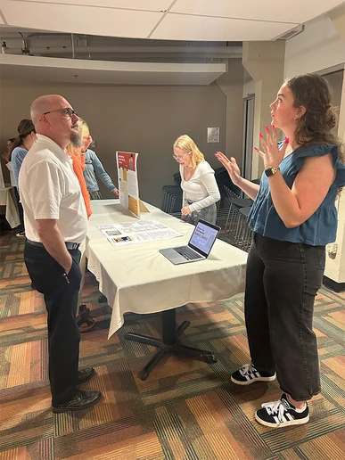 Social Work student describes her project to Dean Andy Karafa