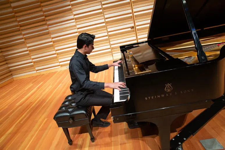 Zarin Mehta performs on the piano in Rosch Recital Hall.