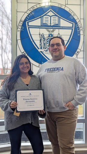 Ximena Ramirez Hernandez displays her Resident of the Month certificate, accompanied by Residence Director Ronny Nissen.