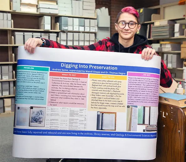Andrew Semo, with his poster presentation, in Special Collections and Archives in Reed Library.