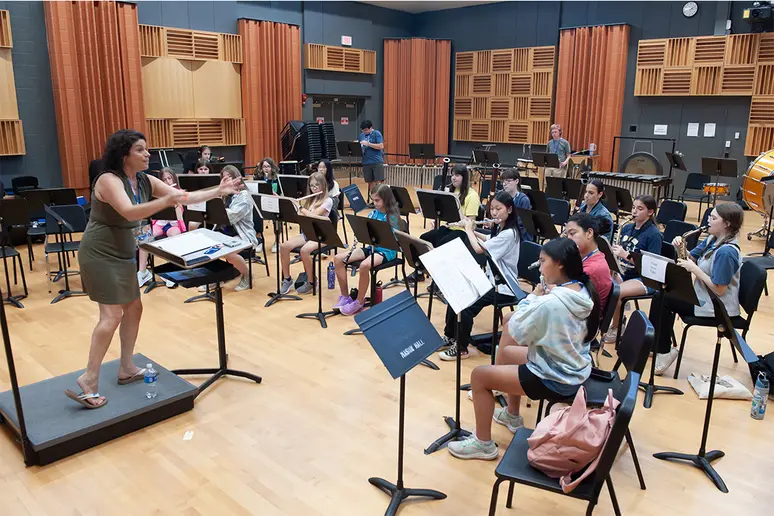 Christina Helbock, a guest conductor from Brentwood High School on Long Island, NY, conducts the middle school woodwind and percussion choir.