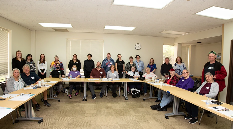 Stroke/head injury survivors, with family members and friends, join Department of Communication Disorders and Sciences students and staff who conduct support meetings for a group photograph at the celebration commemorating the 20th anniversary of the support program.