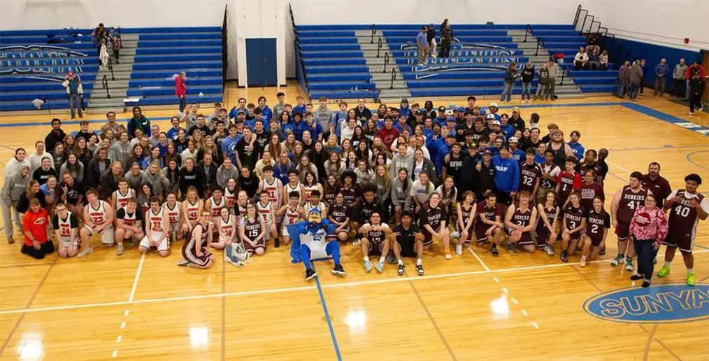 basketball players and fans on court