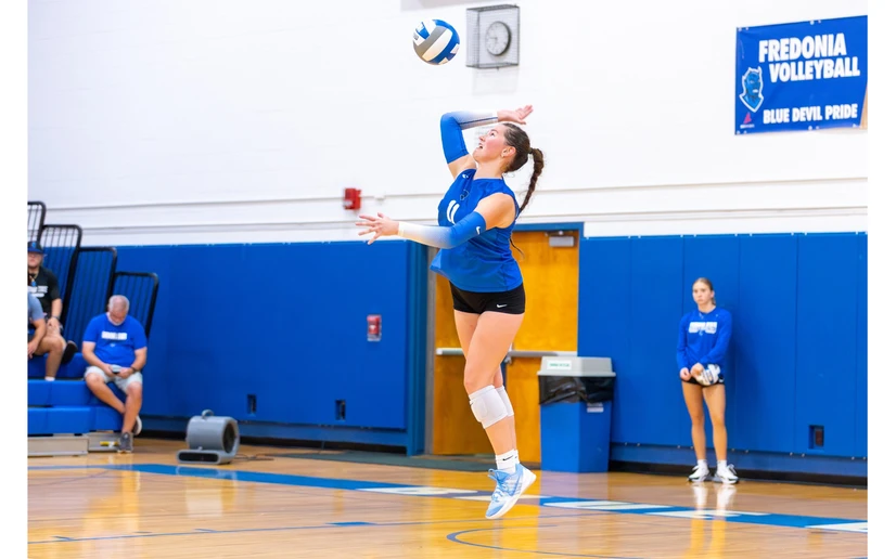 volleyball player serving by Travis Bernhard