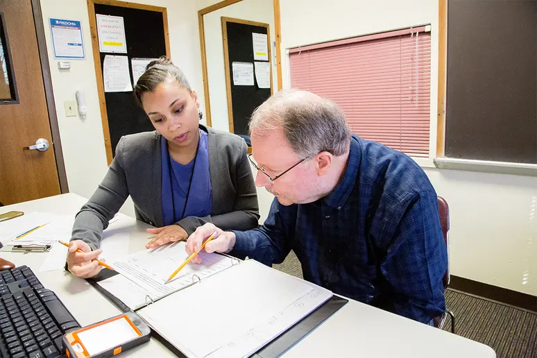 Staff of the Henry C. Youngerman Center work with a client.