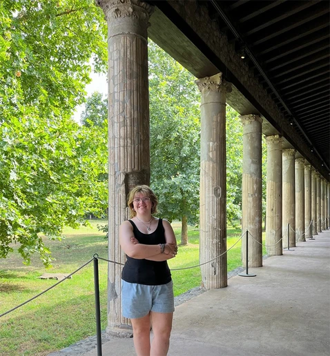 Abby Conklin, along a row of columns in the ancient city of Pompeii, Italy, during her summer internship.